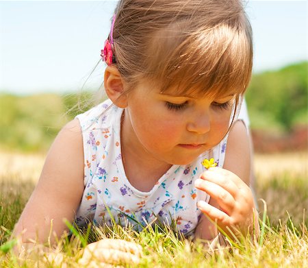 small babies in park - Little girl olfact flower and lying on grass in the park Stock Photo - Budget Royalty-Free & Subscription, Code: 400-04416786