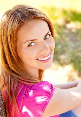 raysay (artist) - Adorable young woman wearing pink t-shirt and posing in the park Foto de stock - Royalty-Free Super Valor e Assinatura, Número: 400-04416781