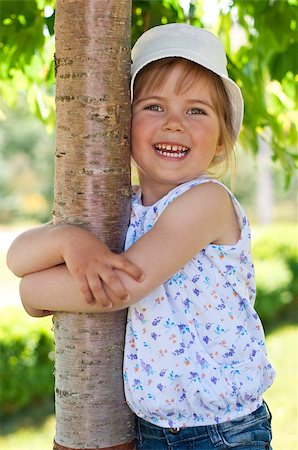 raysay (artist) - Little adorable girl posing by tree in the park Foto de stock - Royalty-Free Super Valor e Assinatura, Número: 400-04416791