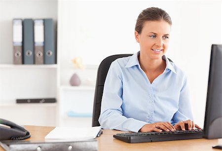 simsearch:400-04894274,k - Office worker typing on a keyboard in her office Stock Photo - Budget Royalty-Free & Subscription, Code: 400-04417273