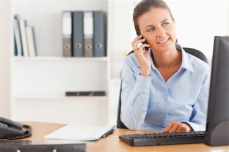 simsearch:400-04008684,k - Working woman speaking on the phone in her office Stockbilder - Microstock & Abonnement, Bildnummer: 400-04417289