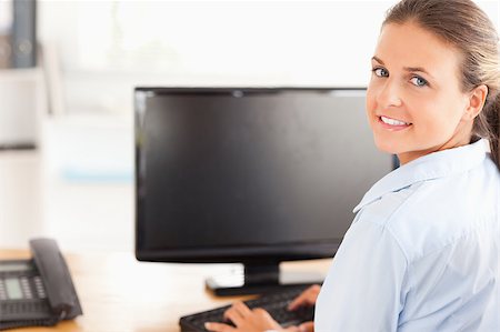 simsearch:400-04894274,k - Office worker using her computer in her office Stock Photo - Budget Royalty-Free & Subscription, Code: 400-04417297