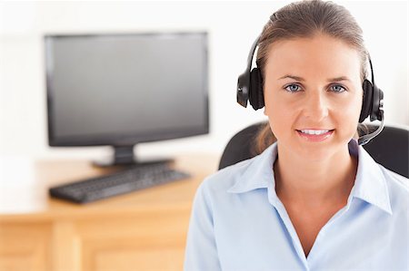simsearch:400-04472832,k - Office worker wearing a headset posing  in her office Stock Photo - Budget Royalty-Free & Subscription, Code: 400-04417305
