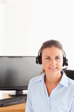 simsearch:400-04472832,k - Secretary wearing a headset posing Stock Photo - Budget Royalty-Free & Subscription, Code: 400-04417302