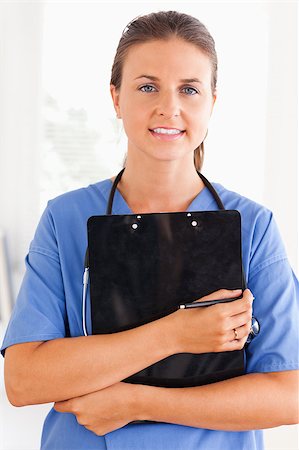 simsearch:400-04024679,k - Close up of a nurse holding a folder looking at the camera Stockbilder - Microstock & Abonnement, Bildnummer: 400-04417341