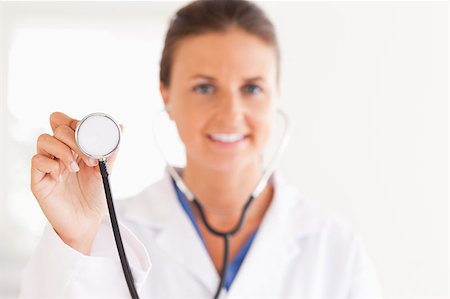 simsearch:400-05892402,k - gorgeous doctor showing stethoscope to the camera in her surgery Stock Photo - Budget Royalty-Free & Subscription, Code: 400-04417391