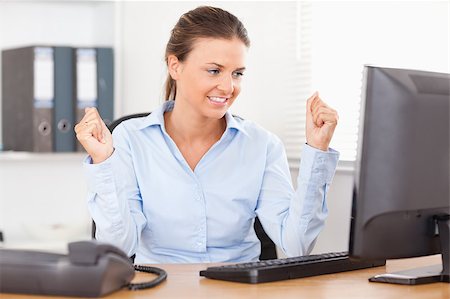simsearch:400-04894274,k - A businesswoman sitting in front of her pc is happy Stock Photo - Budget Royalty-Free & Subscription, Code: 400-04417420