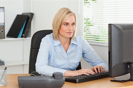 Working woman in front of a screen in an office Stock Photo - Budget Royalty-Free & Subscription, Code: 400-04417560