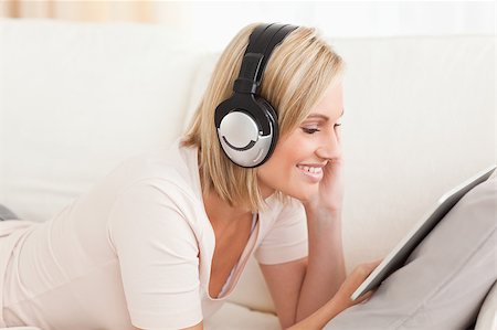 simsearch:400-04905827,k - Close up of a woman watching a movie with a tablet computer in her living room Stock Photo - Budget Royalty-Free & Subscription, Code: 400-04418448