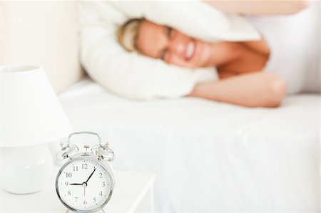 simsearch:6109-06194402,k - Angry blonde woman waking up in her bedroom Stock Photo - Budget Royalty-Free & Subscription, Code: 400-04418606