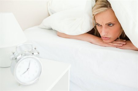 simsearch:400-04287303,k - Displeased woman waking up in her bedroom Stock Photo - Budget Royalty-Free & Subscription, Code: 400-04418609