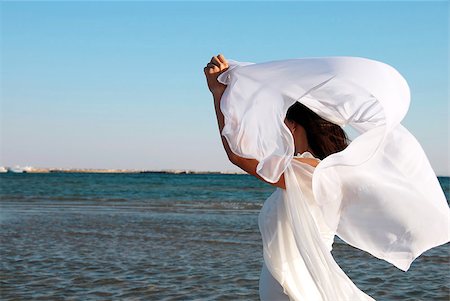 woman in white dress with flying scarf and raised hands on seaside Stock Photo - Budget Royalty-Free & Subscription, Code: 400-04418938