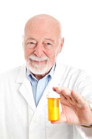 Friendly pharmacist holding a prescription bottle of pills.  White background. Foto de stock - Super Valor sin royalties y Suscripción, Código: 400-04419062