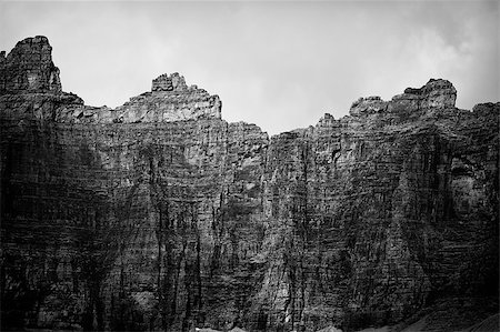 The headwall of the cirque that looms over Iceberg Lake. The cliffs on the mountains form a perfect ampitheater around the lake. Shadows from clouds provide contrast. In black and white. Stock Photo - Budget Royalty-Free & Subscription, Code: 400-04419137