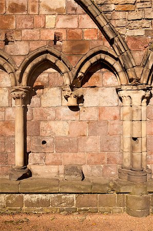 simsearch:400-05705183,k - The exterior wall of the Holyrood Abbey is constructed with a series of stones filling smaller gothic arches. This one segment of the ruins shows a missing pillar with the repeated arch motif. Stock Photo - Budget Royalty-Free & Subscription, Code: 400-04419139