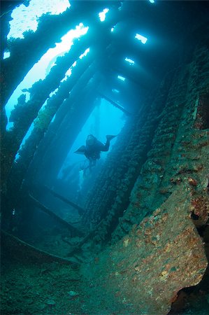 simsearch:400-04403547,k - Scuba diver exploring the interior of a large shipwreck Stock Photo - Budget Royalty-Free & Subscription, Code: 400-04419251