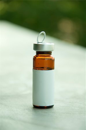 Small bottle for medicines. With white empty label Stock Photo - Budget Royalty-Free & Subscription, Code: 400-04419473