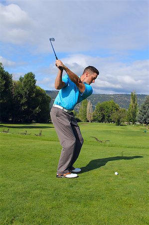simsearch:400-03997921,k - Young golfer hitting a shot with an iron Stock Photo - Budget Royalty-Free & Subscription, Code: 400-04419954