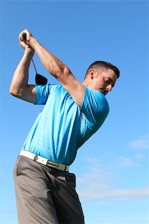 simsearch:400-05038623,k - Young golfer driving with a wood against cloudy skies Stock Photo - Budget Royalty-Free & Subscription, Code: 400-04419955