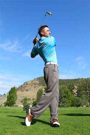 simsearch:400-05038623,k - Young golfer hitting a shot with an iron Stock Photo - Budget Royalty-Free & Subscription, Code: 400-04419953