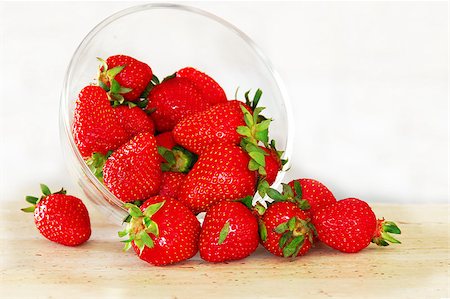 strawberry cup - fresh appetizing red strawberries scattered from in glass bowl Stock Photo - Budget Royalty-Free & Subscription, Code: 400-04410102