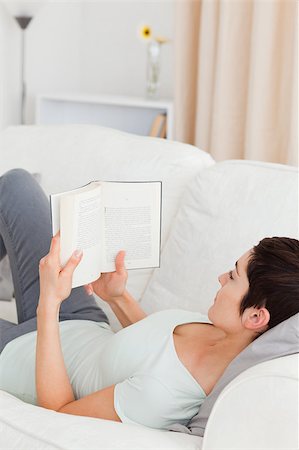 Short-haired woman reading a book in her living room Stock Photo - Budget Royalty-Free & Subscription, Code: 400-04410587