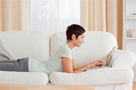 Short-haired woman using a laptop in her living room Stock Photo - Budget Royalty-Free & Subscription, Code: 400-04410634