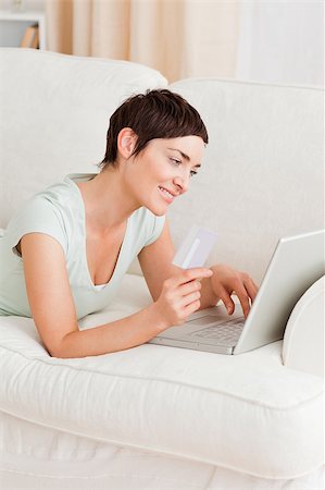 simsearch:400-05742016,k - Portrait of a woman shopping online in her living room Stock Photo - Budget Royalty-Free & Subscription, Code: 400-04410661