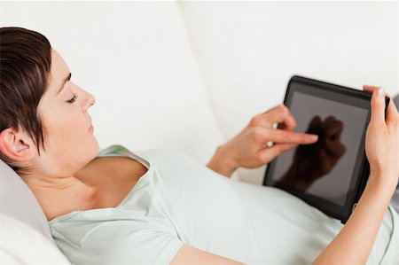 simsearch:6109-06194868,k - Young woman using a tablet computer in her living room Stock Photo - Budget Royalty-Free & Subscription, Code: 400-04410692