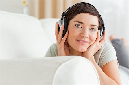 Close up of a short-haired brunette listening to music looking at the camera Stock Photo - Budget Royalty-Free & Subscription, Code: 400-04410728