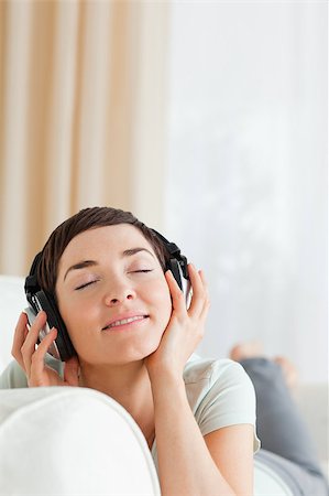Portrait of a short-haired brunette listening to music with her eyes closed Stock Photo - Budget Royalty-Free & Subscription, Code: 400-04410731