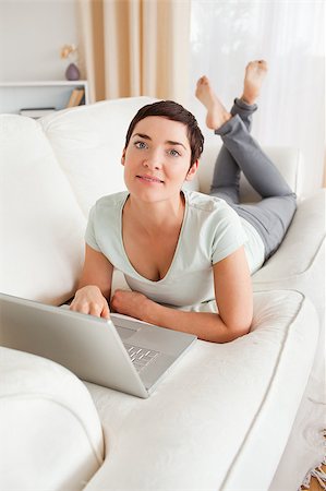 Portrait of a dark-haired woman with a laptop looking at the camera Stock Photo - Budget Royalty-Free & Subscription, Code: 400-04410745
