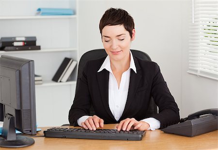 simsearch:400-04894274,k - Secretary typing on her keybord in her office Stock Photo - Budget Royalty-Free & Subscription, Code: 400-04410802