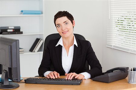 simsearch:400-04894274,k - Young secretary typing on her keybord in her office Stock Photo - Budget Royalty-Free & Subscription, Code: 400-04410824