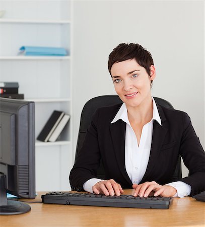 simsearch:400-04894274,k - Portrait of a secretary typing on her keybord in her office Stock Photo - Budget Royalty-Free & Subscription, Code: 400-04410825