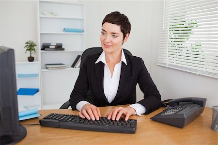 simsearch:400-04894274,k - Charming secretary typing on her keybord in her office Stock Photo - Budget Royalty-Free & Subscription, Code: 400-04410828