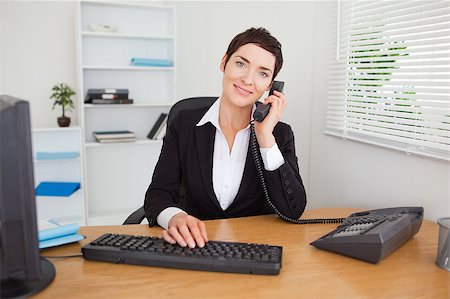 Young secretary answering the phone in her office Stock Photo - Budget Royalty-Free & Subscription, Code: 400-04410830
