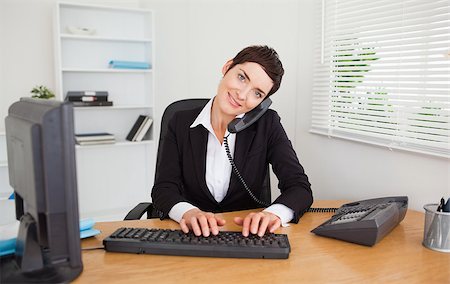 Professional secretary answering the phone in her office Stock Photo - Budget Royalty-Free & Subscription, Code: 400-04410832