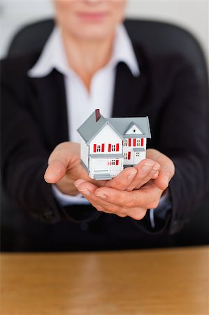 female agent - Portrait of feminine hands holding a miniature house in an office Stock Photo - Budget Royalty-Free & Subscription, Code: 400-04410903