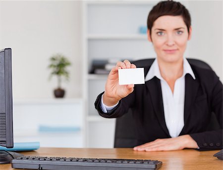 suited person holding paper up - Businesswoman showing a blank business card in her office Stock Photo - Budget Royalty-Free & Subscription, Code: 400-04410925