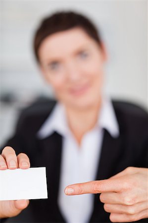 suited person holding paper up - Portrait of a woman showing a blank business card with the camera focus on the object Stock Photo - Budget Royalty-Free & Subscription, Code: 400-04410929