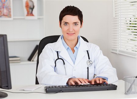 doctor business computer - Female doctor typing with her computer in her office Stock Photo - Budget Royalty-Free & Subscription, Code: 400-04410964