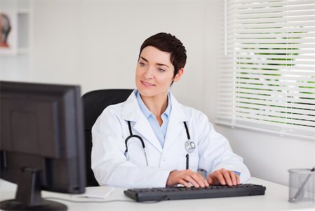 doctor business computer - Charming doctor typing with her computer in her office Stock Photo - Budget Royalty-Free & Subscription, Code: 400-04410967