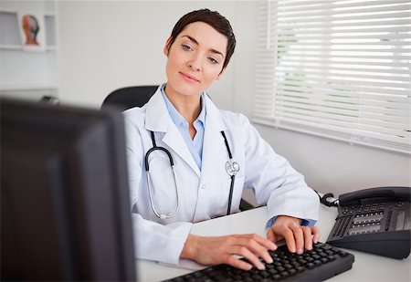 doctor business computer - Doctor updating electronic patient records Stock Photo - Budget Royalty-Free & Subscription, Code: 400-04410988