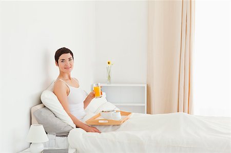 Gorgeous woman having breakfast in her bedroom Stock Photo - Budget Royalty-Free & Subscription, Code: 400-04411043