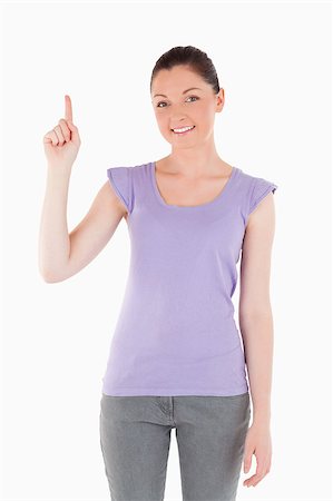 simsearch:400-04925223,k - Pretty woman pointing at a copy space against a white background Stock Photo - Budget Royalty-Free & Subscription, Code: 400-04411172