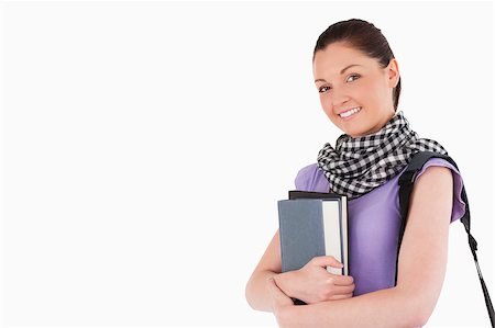 simsearch:400-05156727,k - Good looking student holding books and her bag while standing against a white background Foto de stock - Super Valor sin royalties y Suscripción, Código: 400-04411255