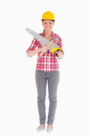 Beautiful woman holding a saw while standing against a white background Stock Photo - Budget Royalty-Free & Subscription, Code: 400-04411279