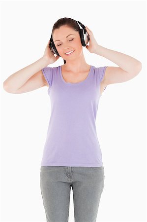 simsearch:400-06690896,k - Gorgeous woman posing with headphones while standing against a white background Stock Photo - Budget Royalty-Free & Subscription, Code: 400-04411454