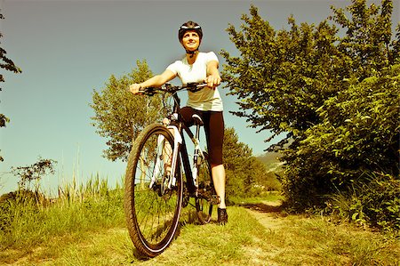 simsearch:400-04890875,k - Young girl riding a bike on a field path - offroad Stock Photo - Budget Royalty-Free & Subscription, Code: 400-04411457